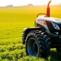 AF88 tractor demonstrating advanced features while plowing a vibrant green field under sunlight