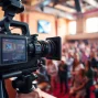 Engaging on-site videography capturing vibrant event moments with a professional camera setup.