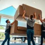 Movers from a top moving company Vancouver handling furniture with care during a residential move.