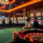Lively casino scene featuring luck8 branded slot machines and a luxurious poker table.