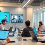 HelloWorld下载 - A diverse team engaging in a seamless video conference with HelloWorld software in a bright modern office.