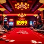 K9K9 game action at a vibrant casino table surrounded by engaging players.